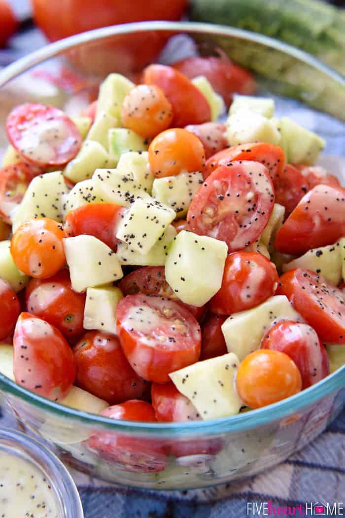 Close-up of Tomato Cucumber Poppy Seed Salad in a glass bowl.