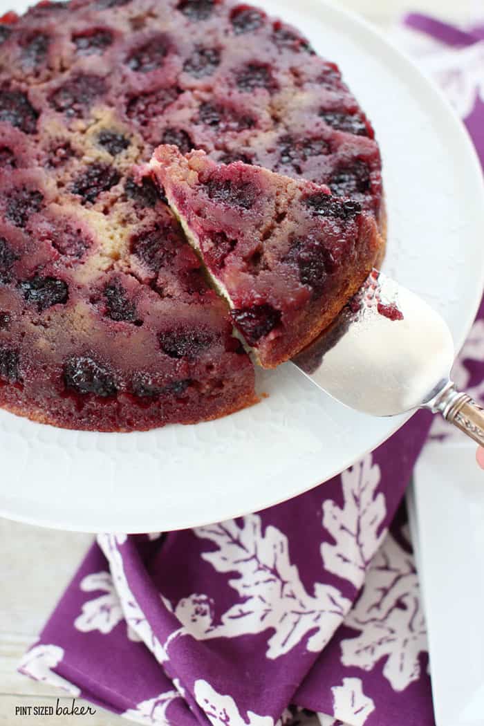Blackberry Upside-Down Almond Skillet Cake ~ studded with almonds and oozing with fresh berries, this simple cake is a delicious summer twist on the popular pineapple dessert! | Pint Sized Baker for FiveHeartHome.com Cake on a platter with the perfect slice being removed
