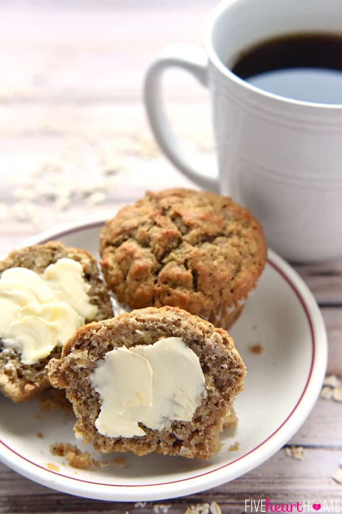 Spiced Oatmeal Muffins ~ perfectly flavored with crunchy tops and pillowy centers, these muffins are a wholesome, delicious breakfast on-the-go or anytime snack! | FiveHeartHome.com Oatmeal muffins on a plate, slathered with butter and served with coffee.