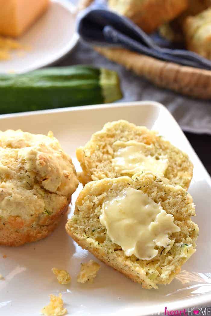 Savory Zucchini Muffins cut in half and spread with butter.