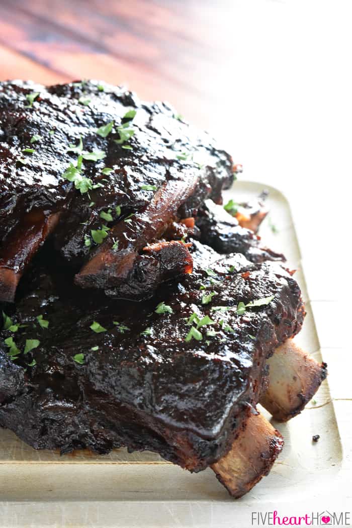 Slow Cooker Baby Back Ribs ~ sticky, smoky, and fall-apart delicious...nobody will ever believe that they came out of the crock pot! | FiveHeartHome.com Crock Pot Ribs on a cutting board, ready to eat