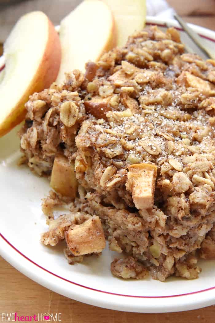 Slice of baked oatmeal on a plate with apple slices.