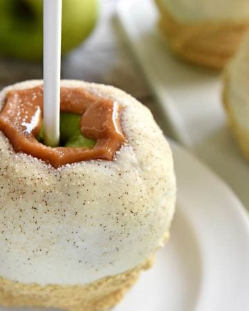 Apple Pie Caramel Apples ~ tart green apples coated in chewy caramel, dipped in white chocolate, and then sprinkled with cinnamon sugar are an uncanny copycat of Disney's famous treat...and they truly taste like apple pie! | FiveHeartHome.com