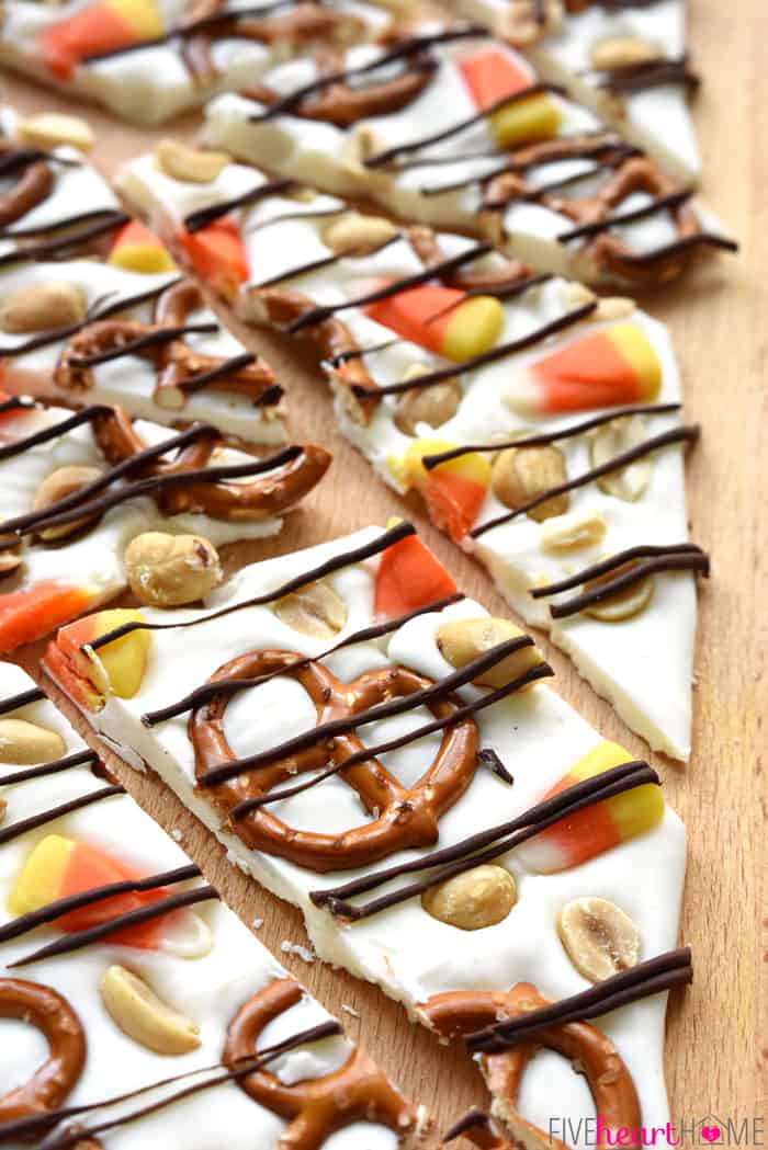 Close-up of Halloween Bark with Candy Corn broken into pieces on a wooden board