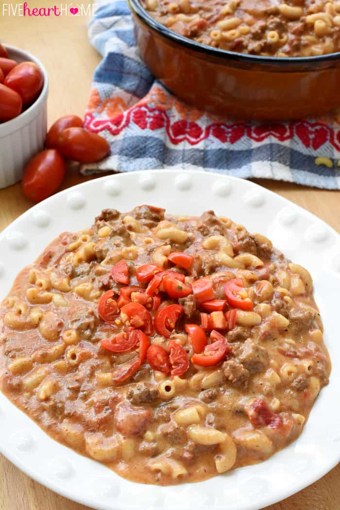 Hamburger Helper Recipe Served in White Bowl with Diced Tomatoes on Top