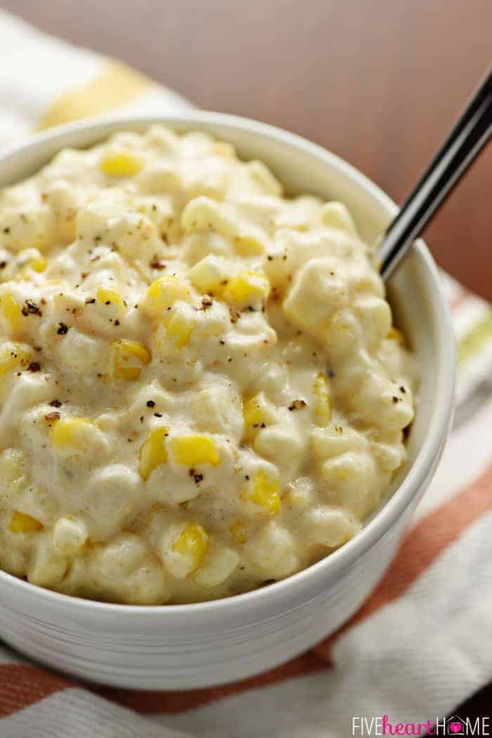 Slow Cooker Creamy Cheesy Corn in a White Bowl on a Tea Towel 