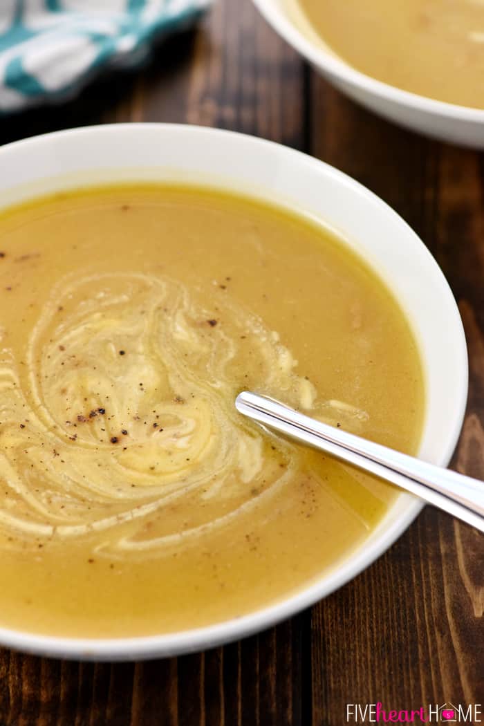 Bowl swirled with sour cream and spoon sticking out