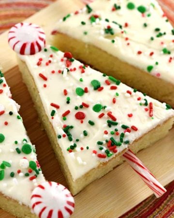 Christmas Tree Sheet Cake Pops ~ tender vanilla sheet cake is slathered in cream cheese frosting, showered with sprinkles, cut into triangles, and embellished with candy canes to make cute & festive treats...perfect for any holiday party or Christmas cookie platter! | FiveHeartHome.com
