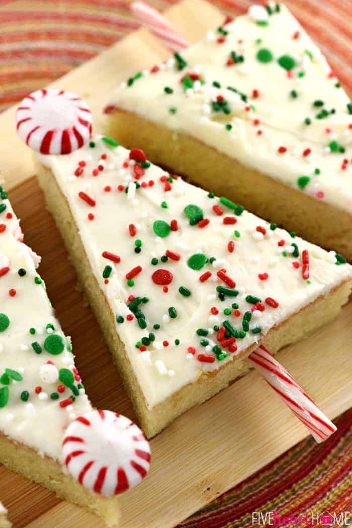 Christmas Sheet Cake slices lined up on wooden board.