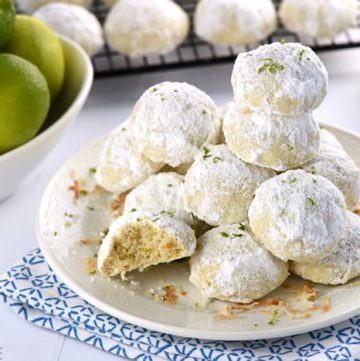 Lime Coconut Snowballs ~ tender shortbread-like cookies studded with lime zest & toasted coconut and generously rolled in powdered sugar for perfect year-round treats...from the lazy days of summer to a Christmas cookie platter! | FiveHeartHome.com