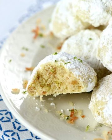 Lime Coconut Snowballs ~ tender shortbread-like cookies studded with lime zest & toasted coconut and generously rolled in powdered sugar for perfect year-round treats...from the lazy days of summer to a Christmas cookie platter! | FiveHeartHome.com