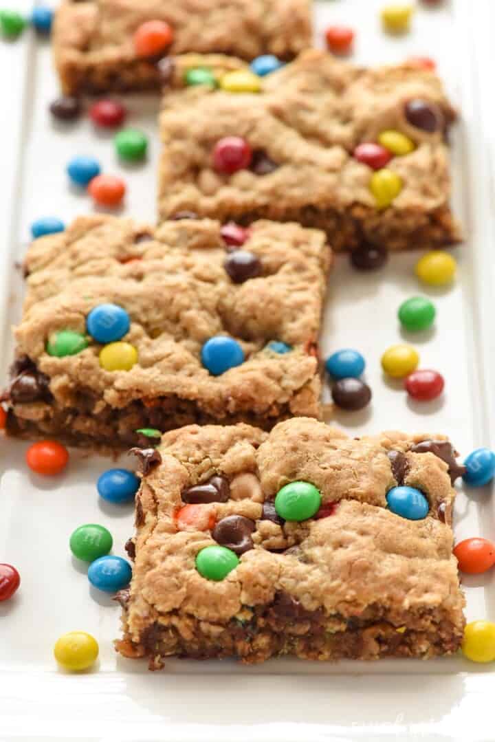Monster Cookie Bars on white platter with mini M&Ms.