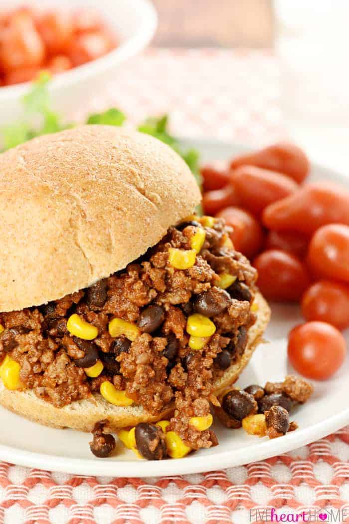 Taco Sloppy Joe sandwich on a plate with grape tomatoes on side