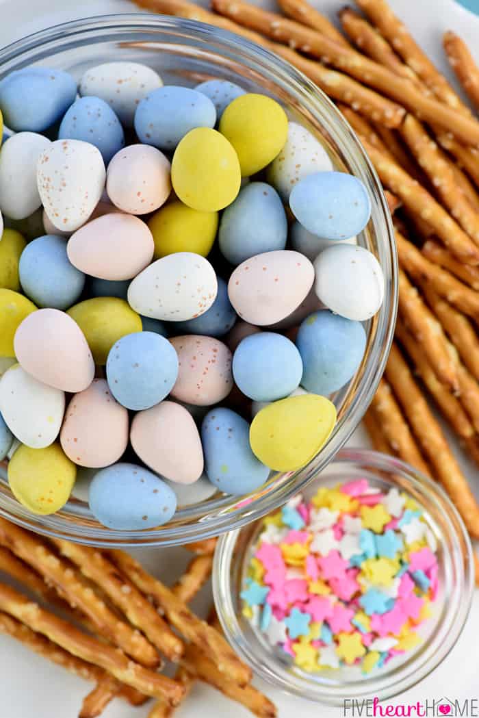 Bowl of Cadbury Mini Chocolate Eggs, pretzel sticks, and star-shaped pastel sprinkles