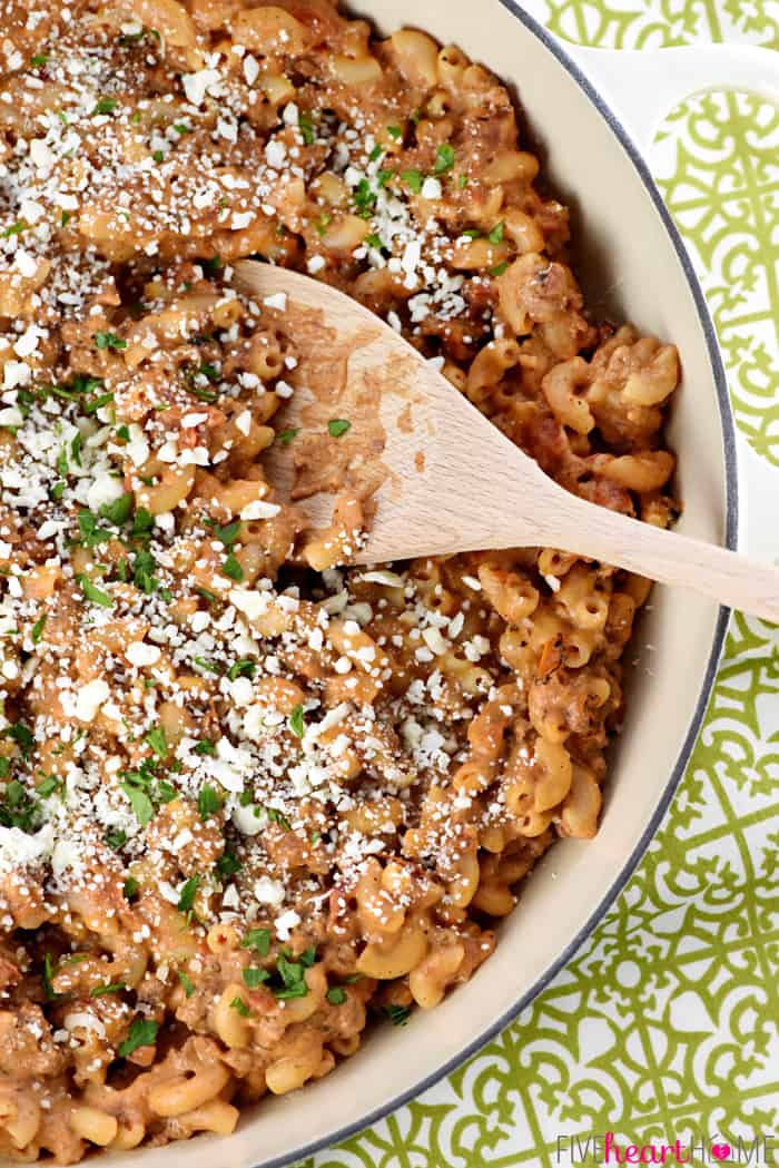 Aerial view of skillet of Pastitsio with wooden spoon.