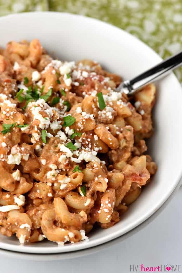 Easy Skillet Pastitsio Recipe ~ a delicious, 30-minute, one-pan dinner of creamy, flavorful Greek lasagna -- loaded with ground beef, tomatoes, pasta, and Greek yogurt! | FiveHeartHome.com Pastitsio recipe in a bowl with parsley and feta on top.