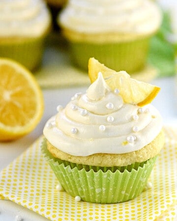 Lemon Cupcakes with Lemon Cream Cheese Frosting on table.