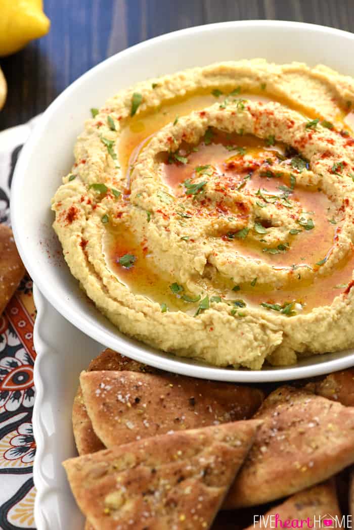 Bowl of Roasted Garlic Hummus with homemade pita chips.