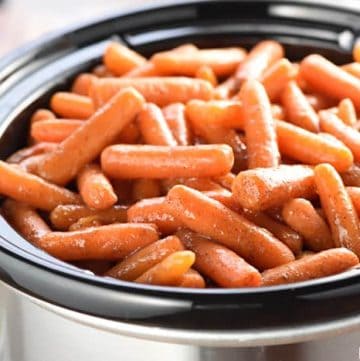 Slow Cooker Honey Cinnamon Carrots ~ a sweet, buttery, and addictive side dish...the perfect recipe for freeing up the oven and feeding a crowd, on Easter, any holiday, or a regular weeknight! | FiveHeartHome.com