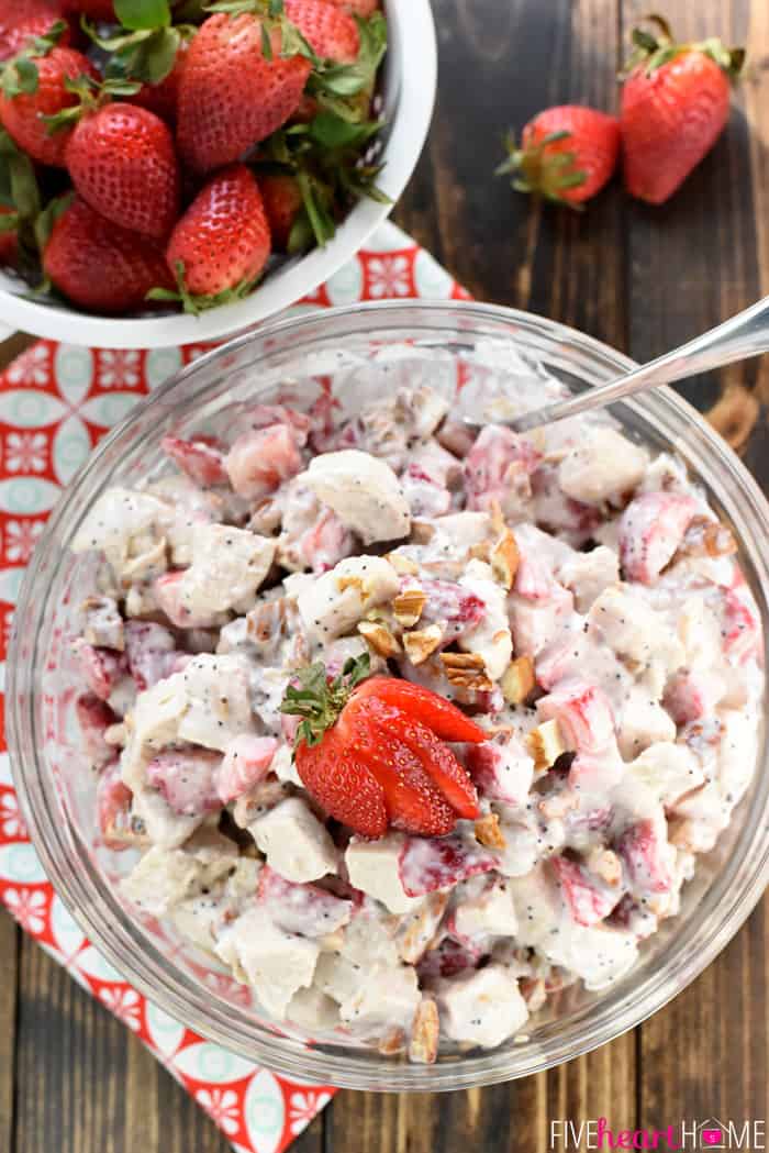 Aerial view of bowl of salad and colander of fresh berries.