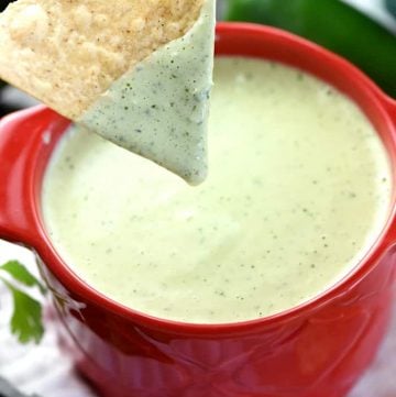 Chip dipped into Chuy's Creamy Jalapeño Dip.