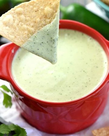 Chip dipped into Chuy's Creamy Jalapeño Dip.