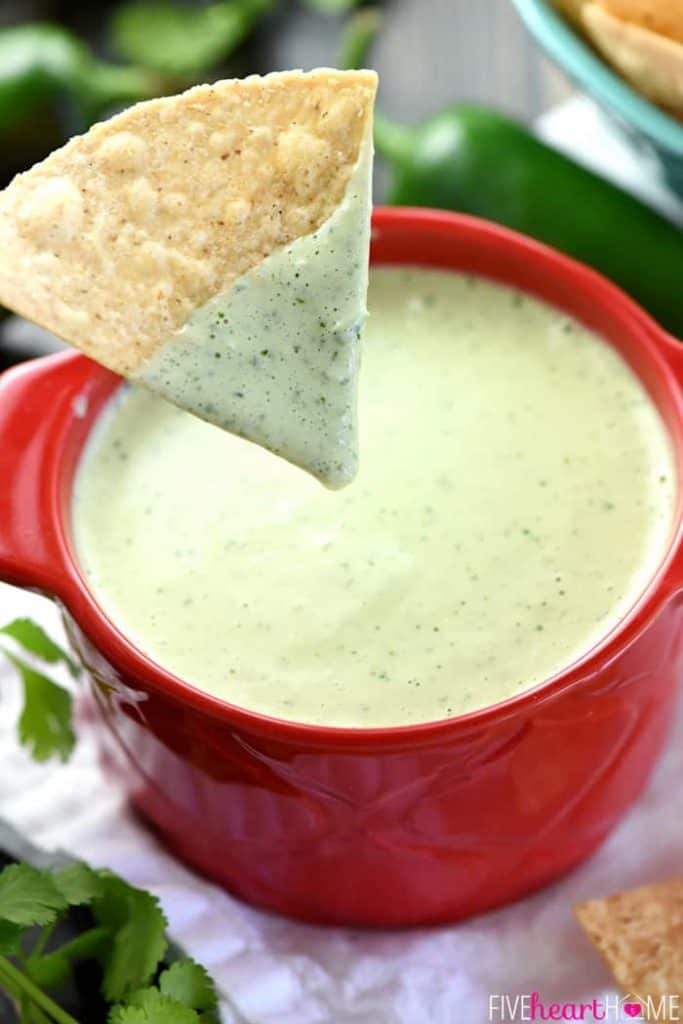 Chip dipped into Chuy's Creamy Jalapeño Dip.