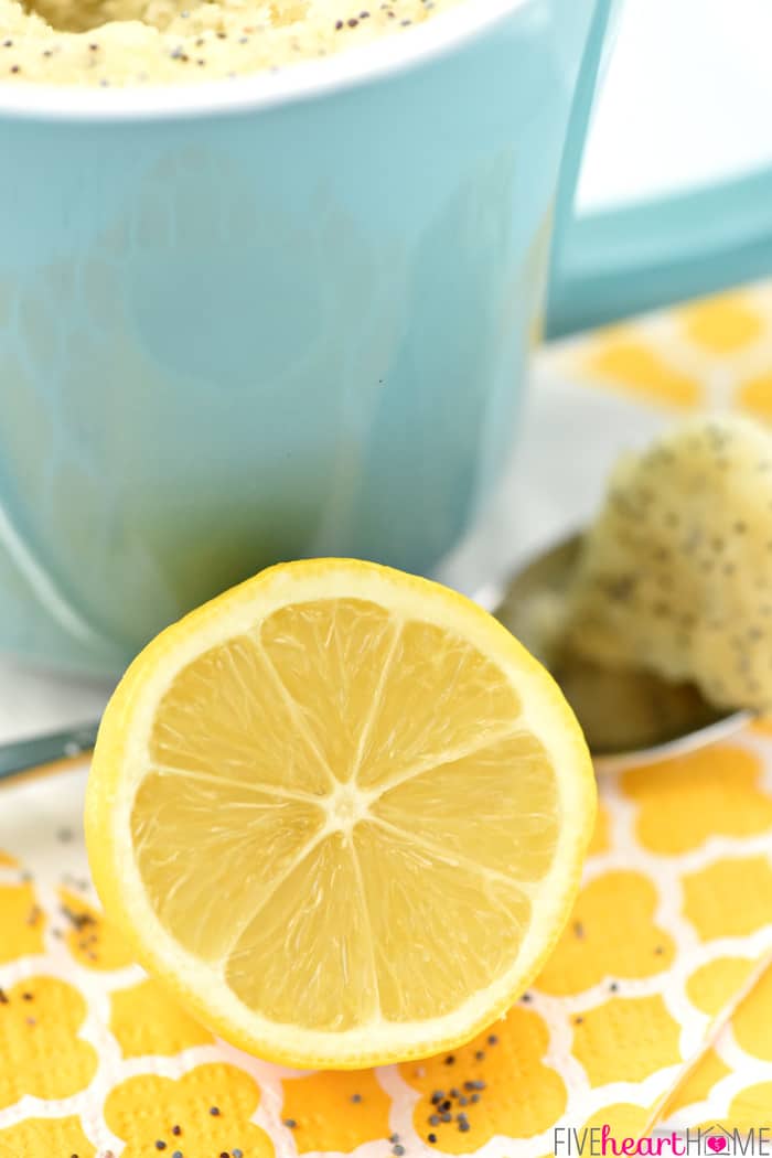 Lemon Mug Cake ~ a quick, tasty, single-serving breakfast or dessert treat, reminiscent of a lemon poppy seed muffin! | FiveHeartHome.com Lemon half leaning on turquoise mug