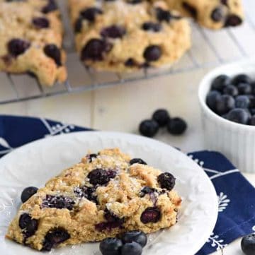 Whole Wheat Scones on cooling rack and plate with blueberries.