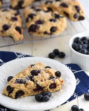 Whole Wheat Scones on cooling rack and plate with blueberries.