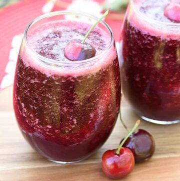 Two glasses of Wine Slushies with cherry garnish.