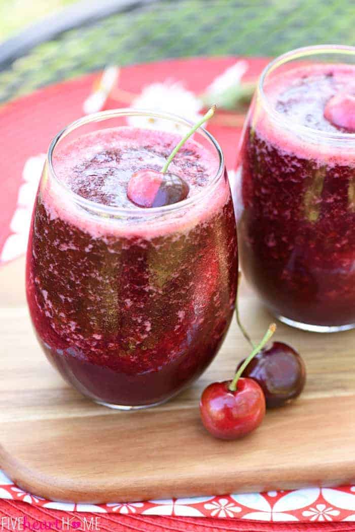 Two glasses of garnished Wine Slushies on cutting board.