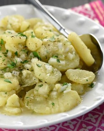 Simple German Potato Salad {Schwäbischer Kartoffelsalat} ~ hailing from the Swabian region of Germany, this delicious recipe features sliced potatoes, minced onions, hot broth, oil, vinegar, and fresh parsley! | FiveHeartHome.com