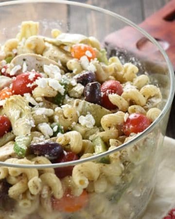 Greek Chicken Pasta Salad ~ marinated chicken, juicy tomatoes, crunchy cucumbers, artichoke hearts, Kalamata olives, and feta cheese are tossed with corkscrew pasta and a tangy dressing in this colorful, flavorful recipe that's perfect for summer barbecues and get-togethers! | FiveHeartHome.com