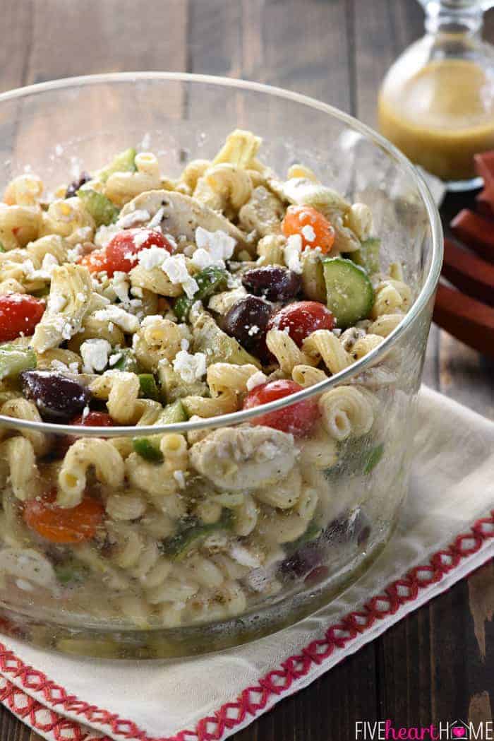Greek Chicken Pasta Salad ~ marinated chicken, juicy tomatoes, crunchy cucumbers, artichoke hearts, Kalamata olives, and feta cheese are tossed with corkscrew pasta and a tangy dressing in this colorful, flavorful recipe that's perfect for summer barbecues and get-togethers! | FiveHeartHome.com