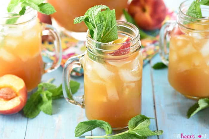 Minty Peach Tea Punch in glasses on table with mint garnish.