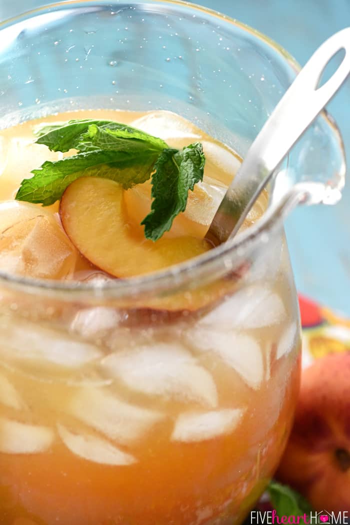 Close-up of Peach Tea Punch in pitcher with spoon.