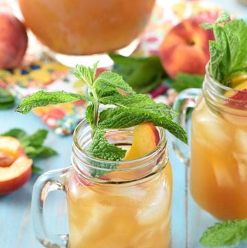 Minty Peach Tea Punch in glasses and pitcher with mint garnish.