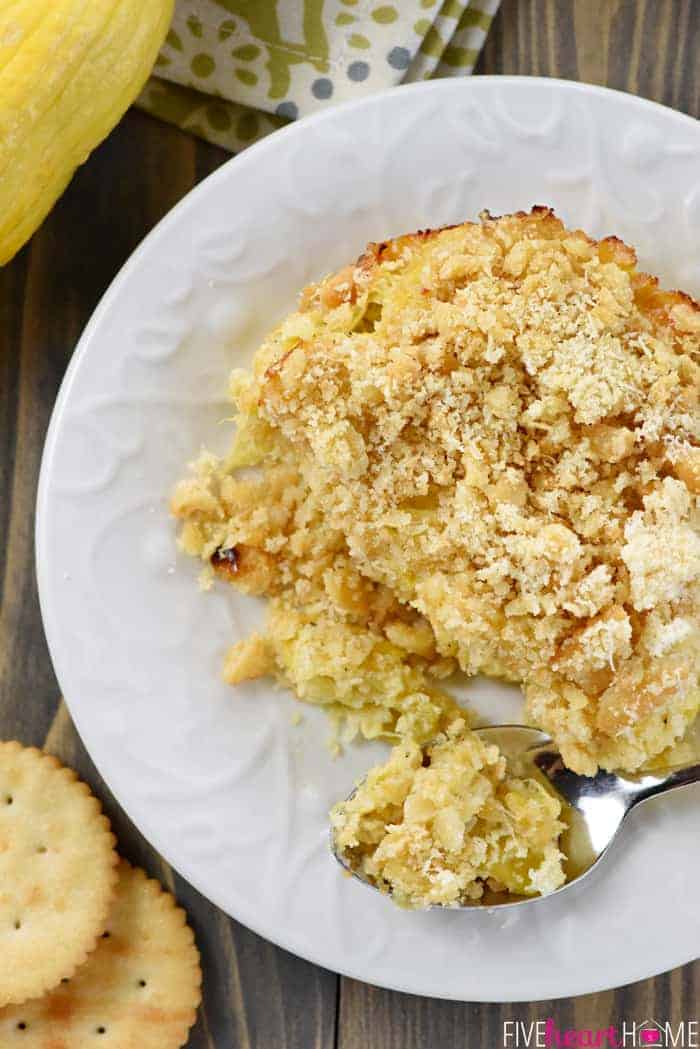 Serving of Squash Casserole on white plate with spoon.