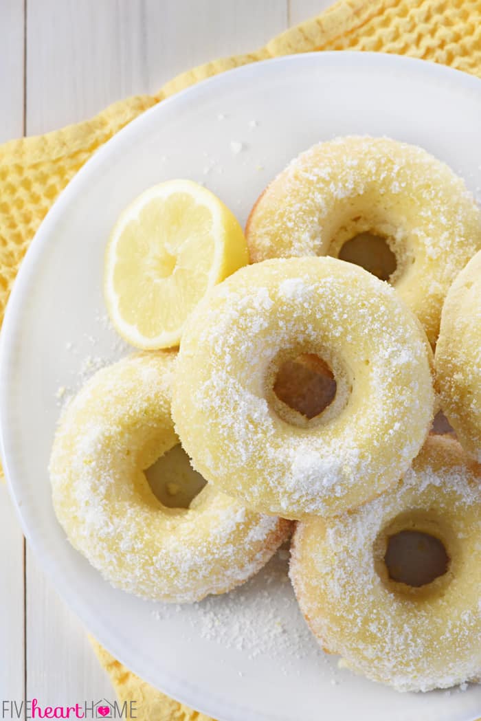 Aerial view of Lemon Sugar Baked Donuts on white plate.