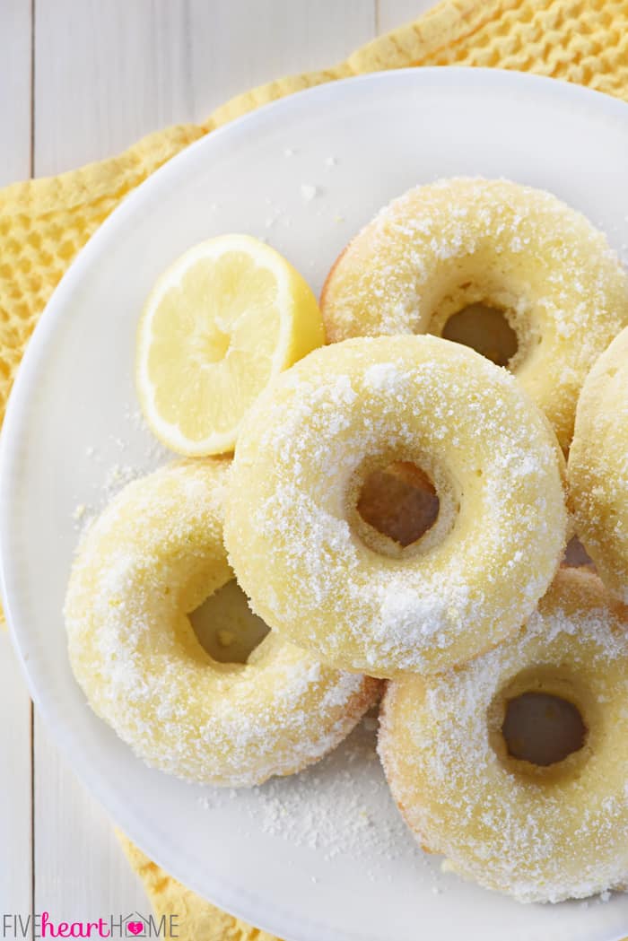 Lemon Sugar Baked Donuts ~ light, citrusy, and generously coated in a crunchy, lemon zest-infused sugar...the perfect sunny treat for breakfast or dessert! | FiveHeartHome.com Aerial view of Lemon Sugar Baked Donuts on white plate.