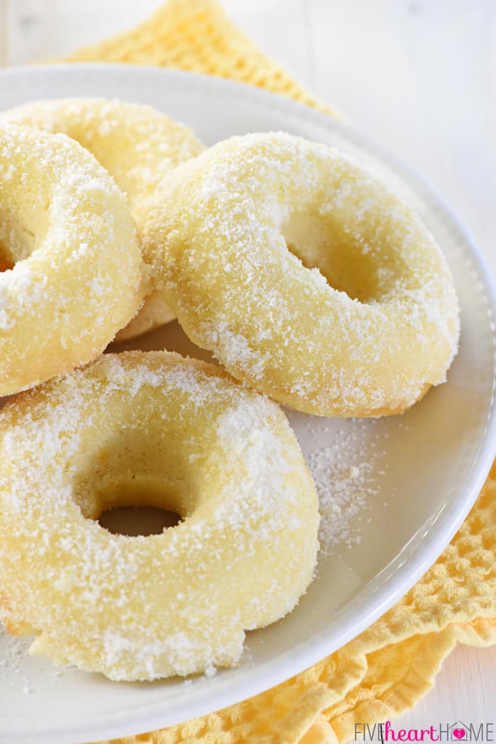Lemon Sugar Baked Donuts ~ light, citrusy, and generously coated in a crunchy, lemon zest-infused sugar...the perfect sunny treat for breakfast or dessert! | FiveHeartHome.com Close-up of baked donuts on plate.