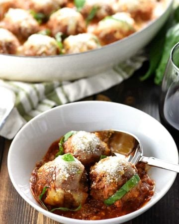 Parmesan Meatball Skillet ~ this easy-to-make, family-pleasing ground beef recipe features tender baked meatballs simmered in marinara and smothered with cheese, delicious served over pasta or piled on meatball subs! | FiveHeartHome.com