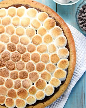 Peanut Butter Cookie S'mores Pizza ~ melted chocolate and toasted marshmallows top a thick, chewy, homemade peanut butter crust in this fun and decadent dessert recipe that's perfect for summer parties or year-round special occasions! | FiveHeartHome.com
