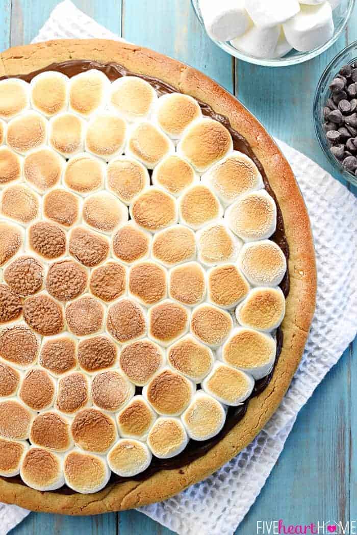 Peanut Butter Cookie S'mores Pizza ~ melted chocolate and toasted marshmallows top a thick, chewy, homemade peanut butter crust in this fun and decadent dessert recipe that's perfect for summer parties or year-round special occasions! | FiveHeartHome.com