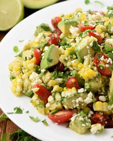 Corn Tomato Avocado Salad on white platter.