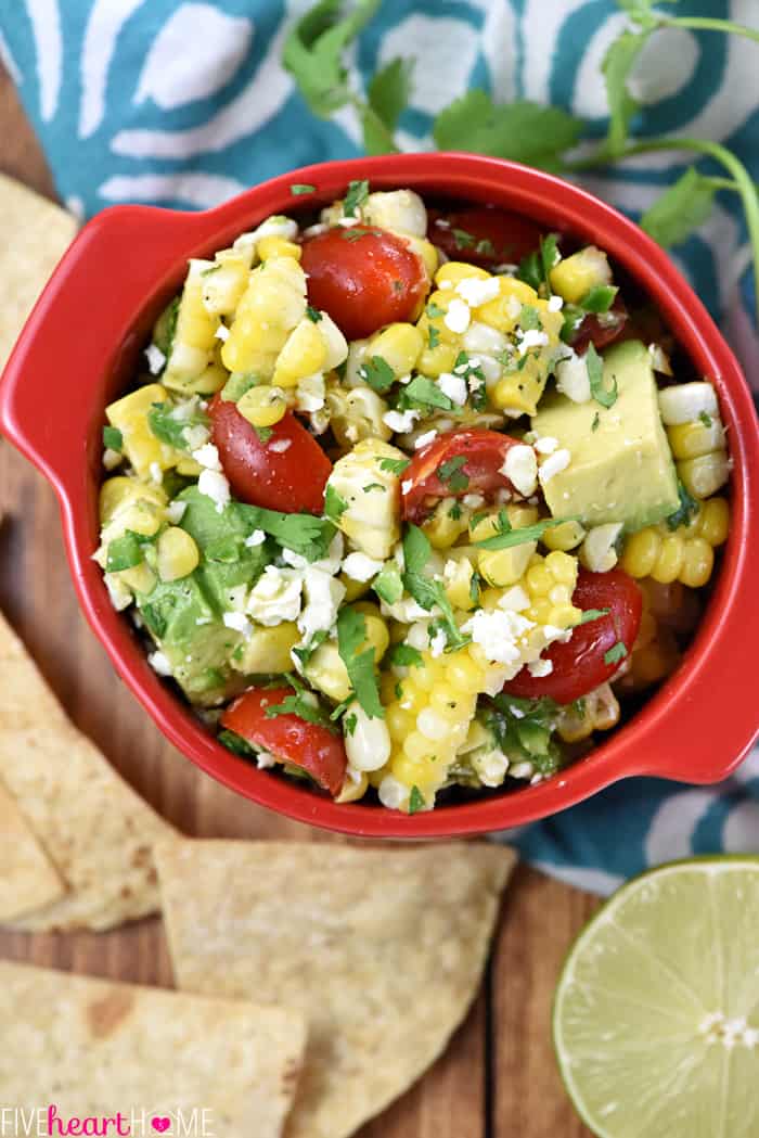 Aerial view of Corn Tomato Avocado Salad in red bowl.