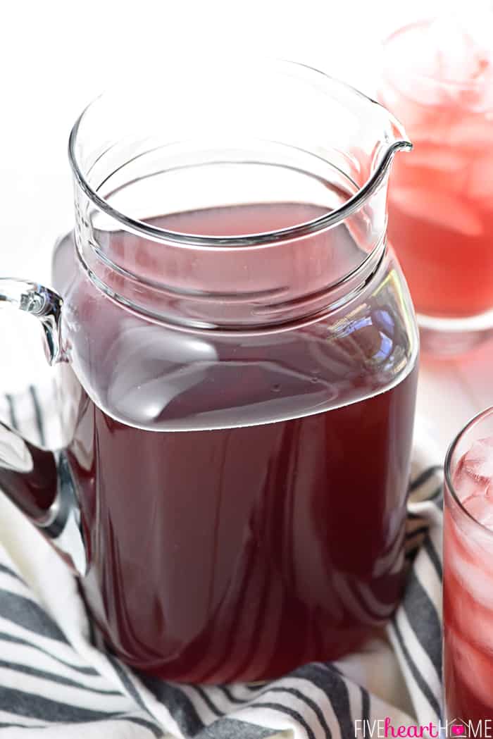 Pitcher of Homemade Gatorade with glasses in background.