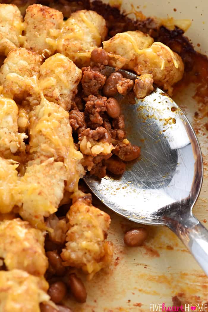 Sloppy Joe Tater Tot Casserole getting scooped up by serving spoon.