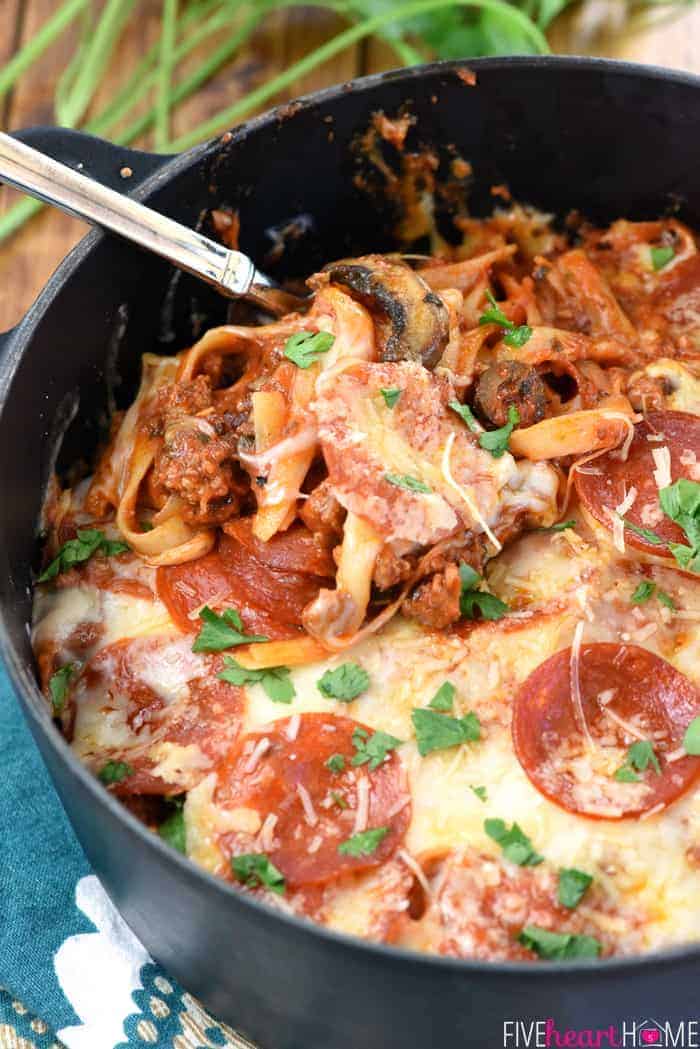 One-Pot Pizza Pasta ~ an easy, cheesy, comforting dinner recipe loaded with flavor thanks to all of your favorite pizza toppings...and as a bonus, everything gets cooked in the same pot! | FiveHeartHome.com Pizza Pasta in pot with serving spoon.